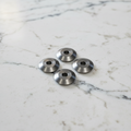 A photo of 4 replacement cutting blades for the Yates wine foil cutter. They are sitting on a white background.