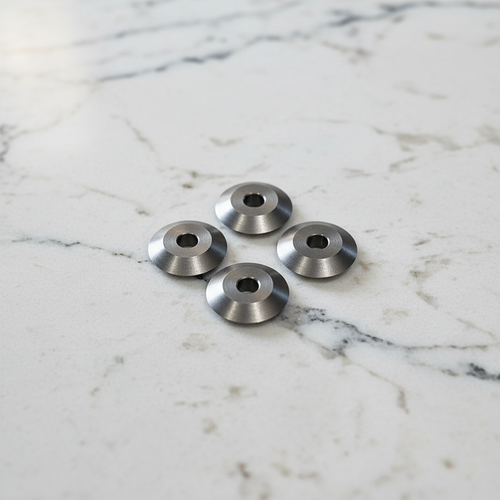 A photo of 4 replacement cutting blades for the Yates wine foil cutter. They are sitting on a white background.