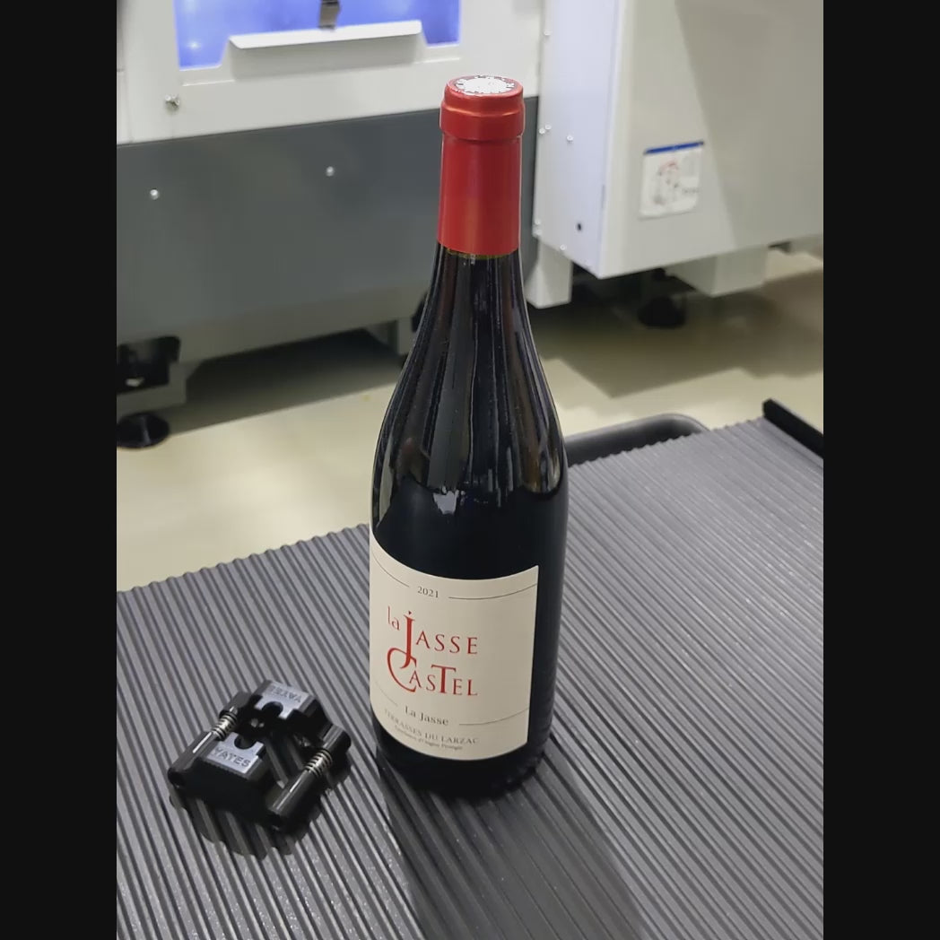 A video showing a man using the Yates wine foil cutter to cut the foil on top of a French made bottle of wine. He places the foil cutter on top of the bottle before rotating it a couple of times to cut the foil. He then puts the foil cutter down before removing the foil cap from the wine bottle and showing the clean cut to the camera. He then puts the cap down and picks up the foil cutter to demonstrate the opening and closing spring loaded action of the foil cutter, before putting the foil cutter down.